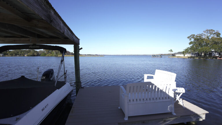 Private dock seating overlooking Lake Tarpon at waterfront rental